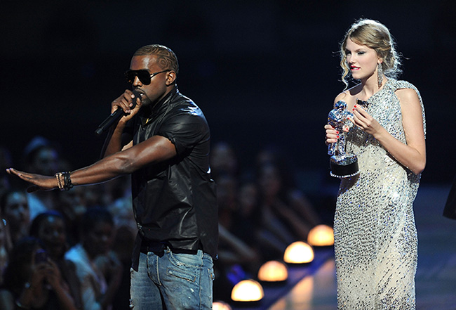 NEW YORK - SEPTEMBER 13:  Kanye West takes the microphone from Taylor Swift and speaks onstage during the 2009 MTV Video Music Awards at Radio City Music Hall on September 13, 2009 in New York City.  (Photo by Kevin Mazur/WireImage)